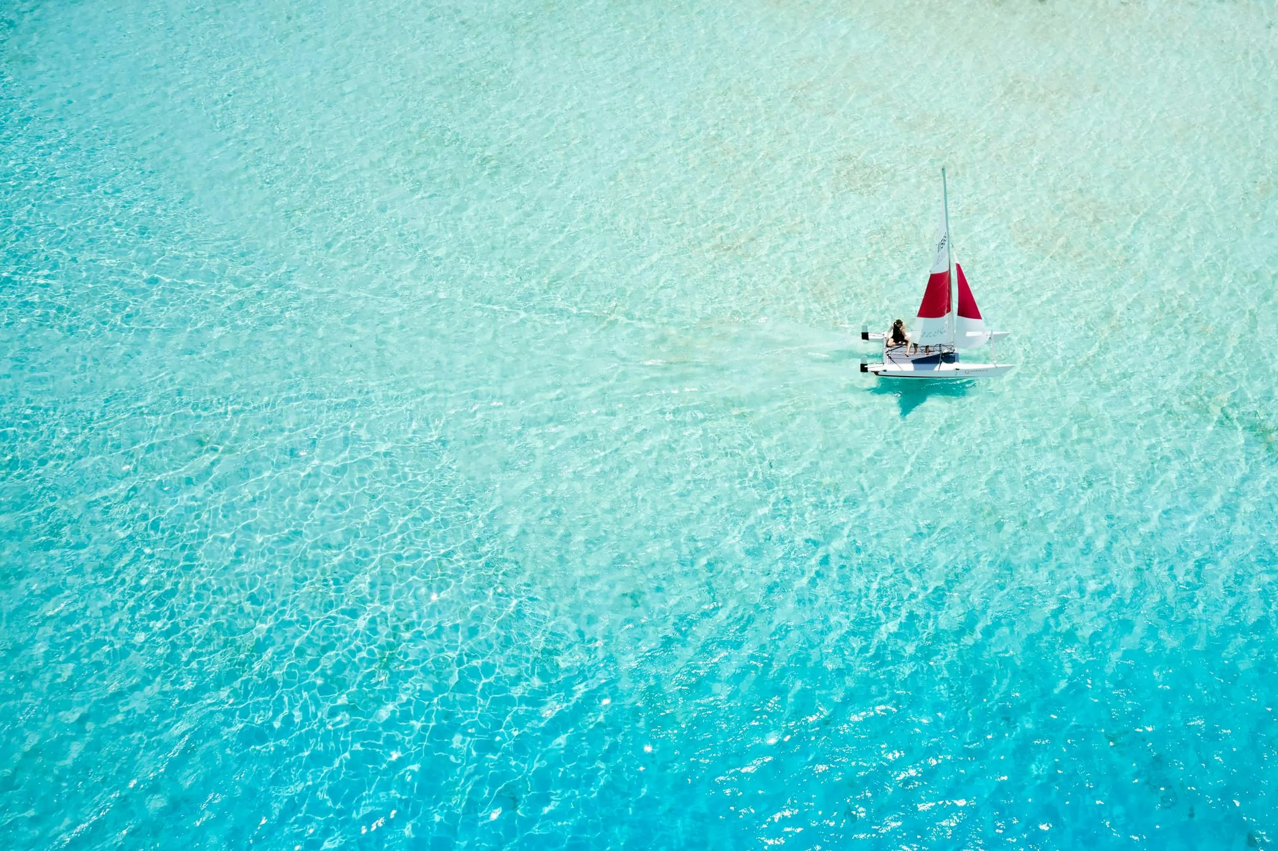 Aerial view of a catamaran sailing near Villa Nautica