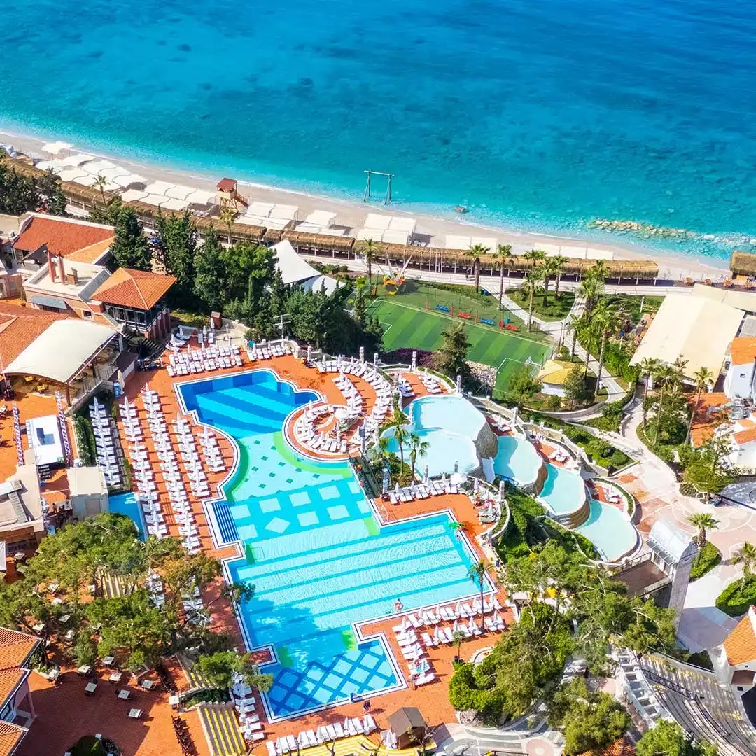 Aerial view of the main pool complex and private beach at Liberty Lykia